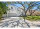 Beautiful two-story home boasts a paver driveway and lush landscaping with mature trees providing shade at 4614 W Lowell Ave, Tampa, FL 33629