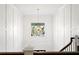 Bright foyer with stylish modern chandelier, accent wall, and natural light from the large window at 4614 W Lowell Ave, Tampa, FL 33629