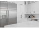 Open concept kitchen with stainless appliances, marble countertops, and custom cabinets at 4614 W Lowell Ave, Tampa, FL 33629