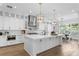 An open-concept kitchen featuring a large island with marble countertops and stainless vent hood at 4614 W Lowell Ave, Tampa, FL 33629