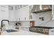 Features custom cabinets, stainless appliances, a marble backsplash, and a stainless vent hood at 4614 W Lowell Ave, Tampa, FL 33629