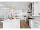 Open concept kitchen with a large island, stainless appliances, and custom white cabinets at 4614 W Lowell Ave, Tampa, FL 33629