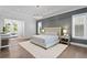 Spacious main bedroom with wood floors, tray ceilings, designer lighting, and inviting sitting area at 4614 W Lowell Ave, Tampa, FL 33629