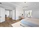 Bright main bedroom with an open doorway leading to a cozy sitting room, hardwood floors, and elegant furniture at 4614 W Lowell Ave, Tampa, FL 33629