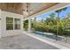 Covered patio overlooking a luxurious pool and lush landscaping creating a private backyard oasis at 4614 W Lowell Ave, Tampa, FL 33629