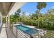 The pool has a black metal fence and is surrounded by lush tropical landscaping at 4614 W Lowell Ave, Tampa, FL 33629