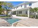 Stunning backyard pool with a modern white home facade and lush landscaping, perfect for outdoor living at 4614 W Lowell Ave, Tampa, FL 33629