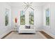 Well-lit sitting area with modern chandelier, natural light, and view of the lush outdoor scenery at 4614 W Lowell Ave, Tampa, FL 33629