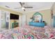 Bright bedroom with a colorful bedspread, ceiling fan and attached bath at 5300 Robin N Ln, St Petersburg, FL 33714