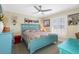 Charming bedroom featuring an accent-colored bed frame and plantation shutters at 5300 Robin N Ln, St Petersburg, FL 33714