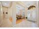 Bright foyer features tile flooring, a decorative chandelier, and a view into the dining room at 5404 Garden Arbor Dr, Lutz, FL 33558