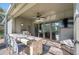 Covered outdoor patio features a complete kitchen with stainless steel grill and bar seating at 5404 Garden Arbor Dr, Lutz, FL 33558