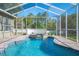 Tranquil screened-in pool area with a spa, lush greenery, and privacy at 5404 Garden Arbor Dr, Lutz, FL 33558