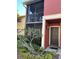 Apartment exterior featuring a welcoming front door, a private balcony and well maintained landscaping at 5553 Baywater Dr, Tampa, FL 33615