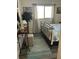 Bright bedroom features a black iron bed, decorative rug, and vanity for an inviting space at 5553 Baywater Dr, Tampa, FL 33615