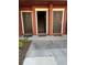 Townhouse building entrance featuring neatly numbered doors and welcome mats, exuding suburban charm at 5553 Baywater Dr, Tampa, FL 33615