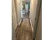 Hallway featuring wood-look flooring, neutral paint, and multiple doorways at 5553 Baywater Dr, Tampa, FL 33615