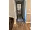 Hallway featuring wood-look flooring, neutral paint, and multiple doorways at 5553 Baywater Dr, Tampa, FL 33615