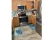 Bright kitchen featuring stainless steel appliances, granite countertops, and wood cabinets at 5553 Baywater Dr, Tampa, FL 33615