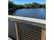 Scenic view of the lake through a wooden and steel railing at 5553 Baywater Dr, Tampa, FL 33615