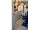 Functional laundry room with appliances, storage shelves, and a light tile floor at 5553 Baywater Dr, Tampa, FL 33615