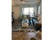 Bright living room with sliders to screened lanai, coastal decor, and neutral furniture at 5553 Baywater Dr, Tampa, FL 33615