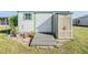 Storage shed exterior with a ramp for easy access and an additional storage cabinet at 5608 Mandan St, Zephyrhills, FL 33542