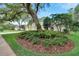 Lovely landscaped front yard featuring mature trees and lush greenery at 5611 Eagleglen Pl, Lithia, FL 33547