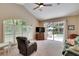 Cozy living room with vaulted ceiling, large windows, and direct access to the pool area at 5611 Eagleglen Pl, Lithia, FL 33547