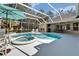 An overhead view shows a screened-in pool with a spa and patio seating at 5611 Eagleglen Pl, Lithia, FL 33547