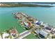 Aerial view of waterfront home with pool, dock, and beautiful water views at 562 Johns Pass Ave, Madeira Beach, FL 33708