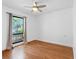 Bedroom with hardwood floors, a ceiling fan, and a window with curtains at 562 Johns Pass Ave, Madeira Beach, FL 33708