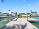 Picture perfect waterfront view from private dock with boat lift showcasing neighborhood and tranquil waterway at 562 Johns Pass Ave, Madeira Beach, FL 33708