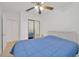 Inviting bedroom with ceiling fan, mirrored closet doors, and a cozy blue comforter at 6013 N Grady Ave, Tampa, FL 33614