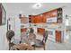 Well-lit kitchen with tile flooring, wooden cabinets, and a breakfast nook with table and chairs at 6013 N Grady Ave, Tampa, FL 33614