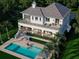 Aerial view of luxury home featuring a large inground pool, manicured yard and waterfront access at 6151 Bayou Grande Ne Blvd, St Petersburg, FL 33703