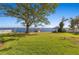 Expansive backyard with lush green lawn and waterfront access, offering a serene outdoor retreat at 6151 Bayou Grande Ne Blvd, St Petersburg, FL 33703