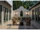 Charming outdoor courtyard with tiled floor, accent wall, and comfortable seating at 6151 Bayou Grande Ne Blvd, St Petersburg, FL 33703