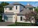 Charming two-story home with a lush green lawn and mature landscaping at 6151 Bayou Grande Ne Blvd, St Petersburg, FL 33703