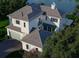 Stunning aerial view of luxury home with a neutral color palette, detailed roof, and waterfront access at 6151 Bayou Grande Ne Blvd, St Petersburg, FL 33703