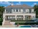 Luxury home with a pool, balcony, manicured landscaping, and exterior lighting at 6151 Bayou Grande Ne Blvd, St Petersburg, FL 33703