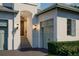 Beautiful home featuring an arched entryway, warm exterior lighting, and a well-manicured lawn at 6151 Bayou Grande Ne Blvd, St Petersburg, FL 33703