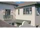 Detailed exterior view showcasing balconies, stylish windows, and elegant lighting fixtures at 6151 Bayou Grande Ne Blvd, St Petersburg, FL 33703