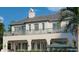 Elegant, light-colored home featuring dual balconies and manicured greenery with a pool at 6151 Bayou Grande Ne Blvd, St Petersburg, FL 33703