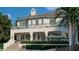 An inviting two-story home featuring a private pool, manicured landscaping and an upper level balcony at 6151 Bayou Grande Ne Blvd, St Petersburg, FL 33703