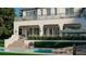 An inviting two-story home featuring a private pool, manicured landscaping and an upper level balcony at 6151 Bayou Grande Ne Blvd, St Petersburg, FL 33703