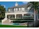 An inviting two-story home featuring a private pool, manicured landscaping and an upper level balcony at 6151 Bayou Grande Ne Blvd, St Petersburg, FL 33703
