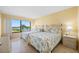 Bedroom featuring twin beds with water view through a large window at 6357 Bahia Del Mar Blvd # 206, St Petersburg, FL 33715