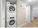 Convenient laundry area with stacked washer and dryer, adjacent to a storage closet and bedroom access at 6357 Bahia Del Mar Blvd # 206, St Petersburg, FL 33715