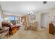 Bright living room with water view and tile flooring complemented by cozy furnishings and a dining area at 6357 Bahia Del Mar Blvd # 206, St Petersburg, FL 33715